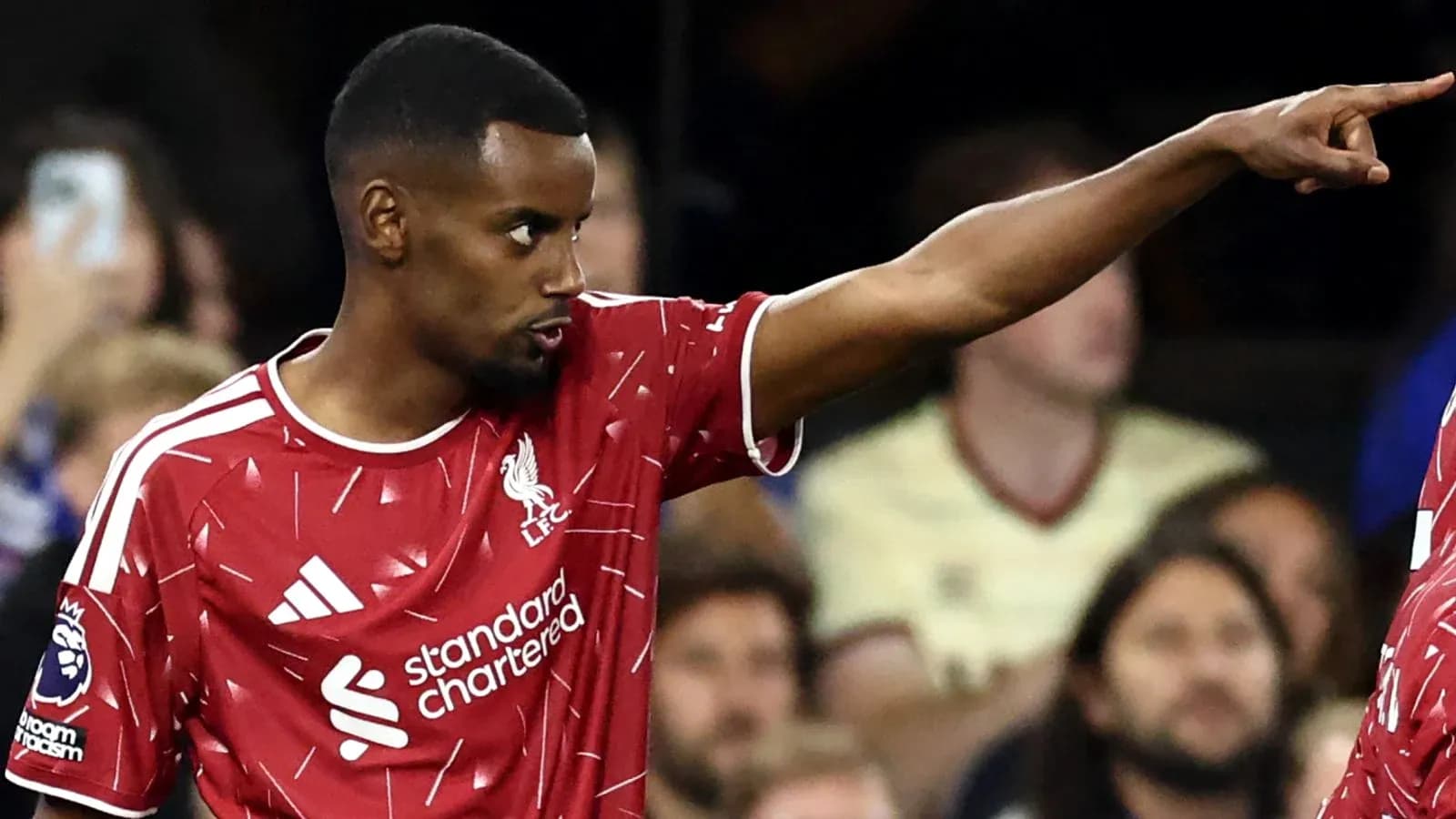 Liverpool player directing teammates during match Liverpool player directing teammates during match