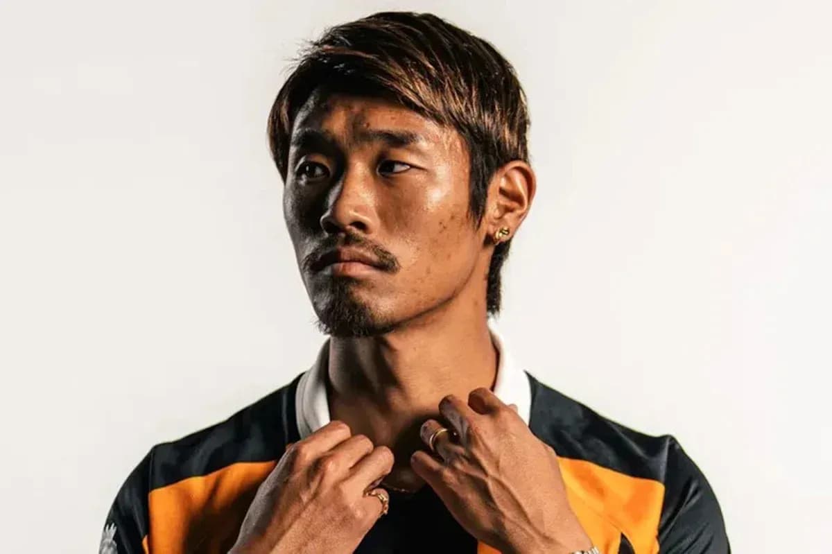Athlete posing in sports jersey against neutral background Athlete posing in sports jersey against neutral background