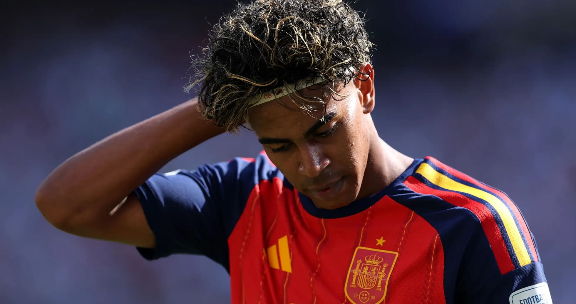 Player in Spain jersey looking down on pitch Player in Spain jersey looking down on pitch