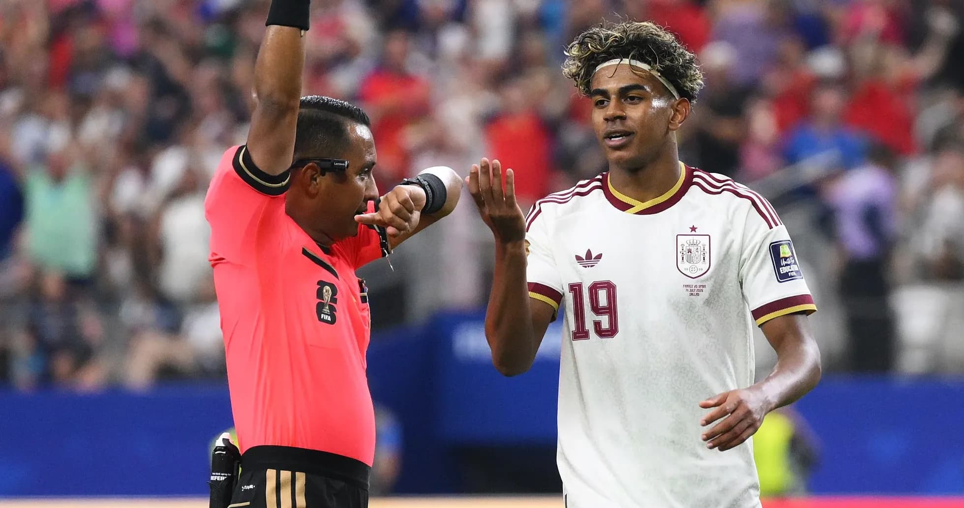 Referee showing a card to Spanish player during match Referee showing a card to Spanish player during match