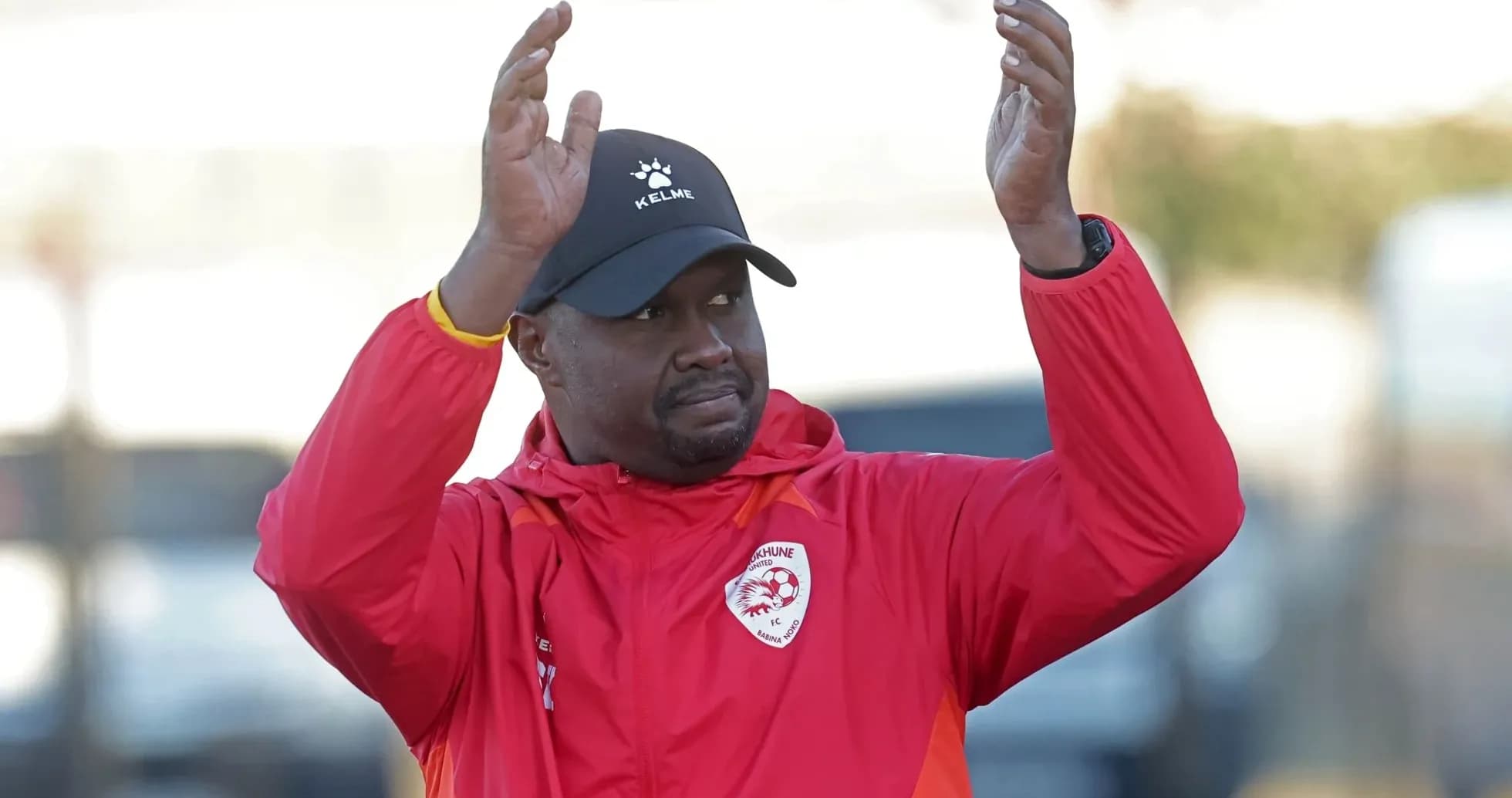 Coach gesturing during training session in red jacket Coach gesturing during training session in red jacket