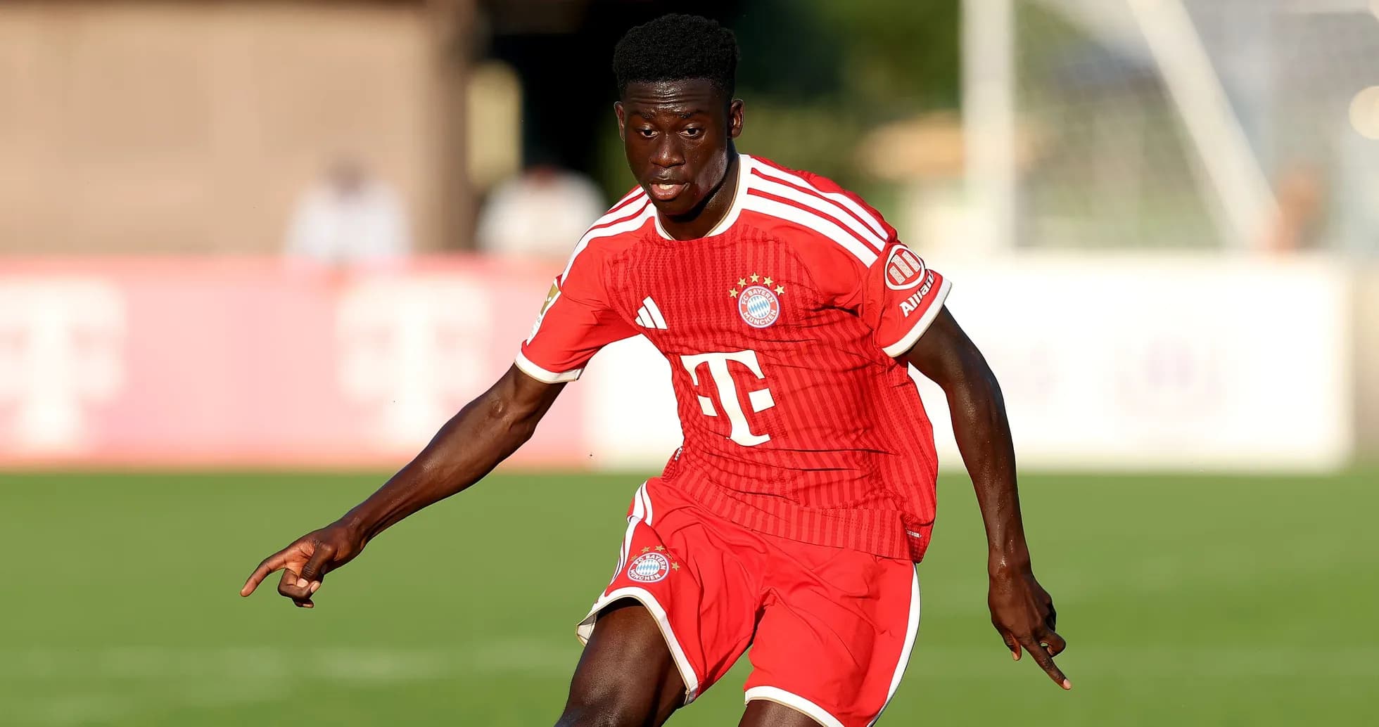 Player in Bayern Munich kit running on the pitch Player in Bayern Munich kit running on the pitch