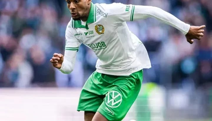 Player sprinting on the field during a match Player sprinting on the field during a match