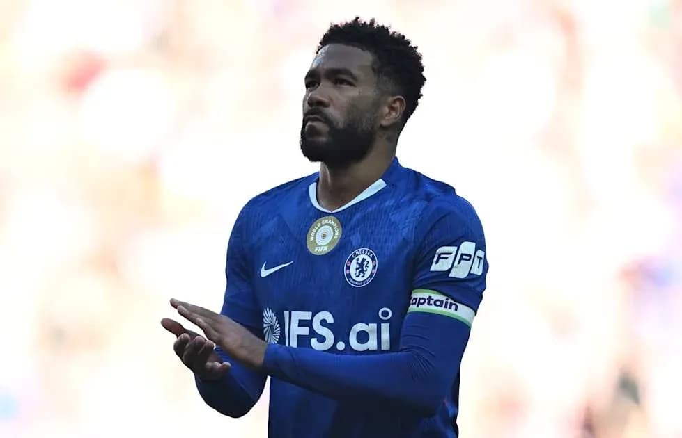 Player in blue jersey clapping on the field Player in blue jersey clapping on the field