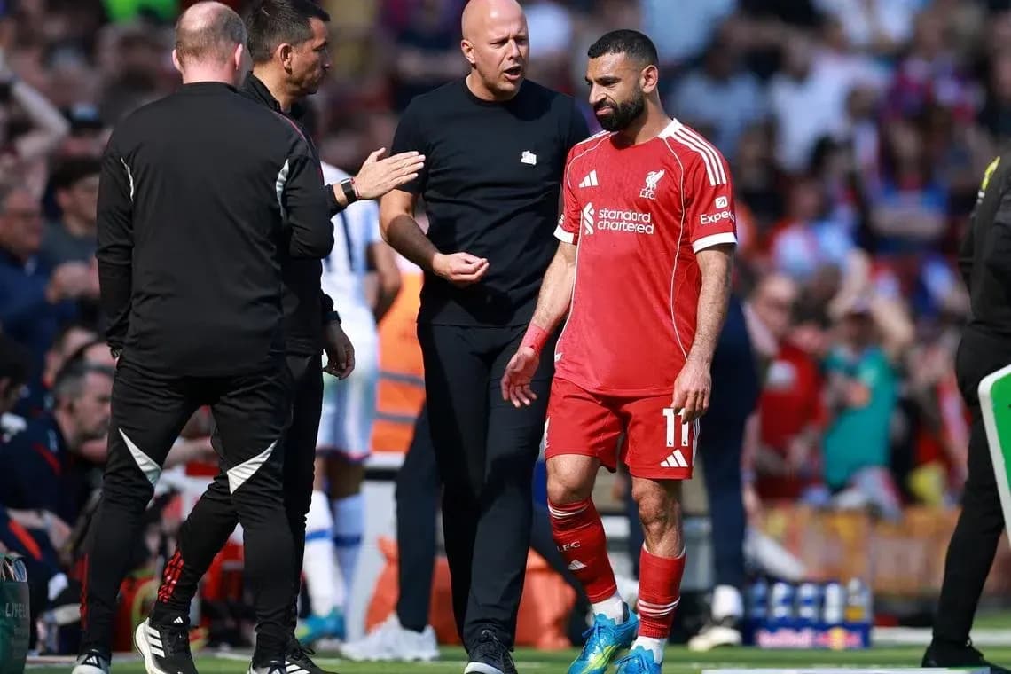 Mohamed Salah leaving the field with team staff Mohamed Salah leaving the field with team staff