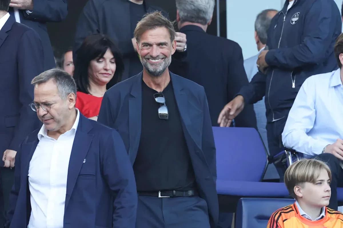 Two men smiling in a crowded venue Two men smiling in a crowded venue