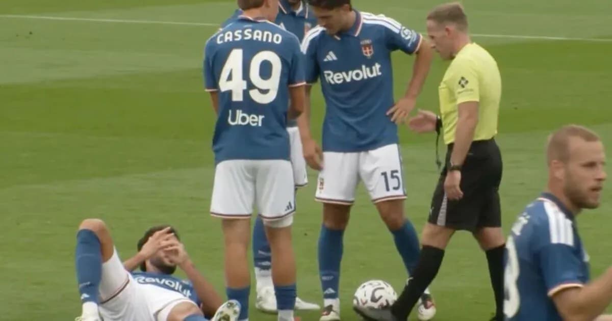 Players gathered around an injured teammate on field Players gathered around an injured teammate on field