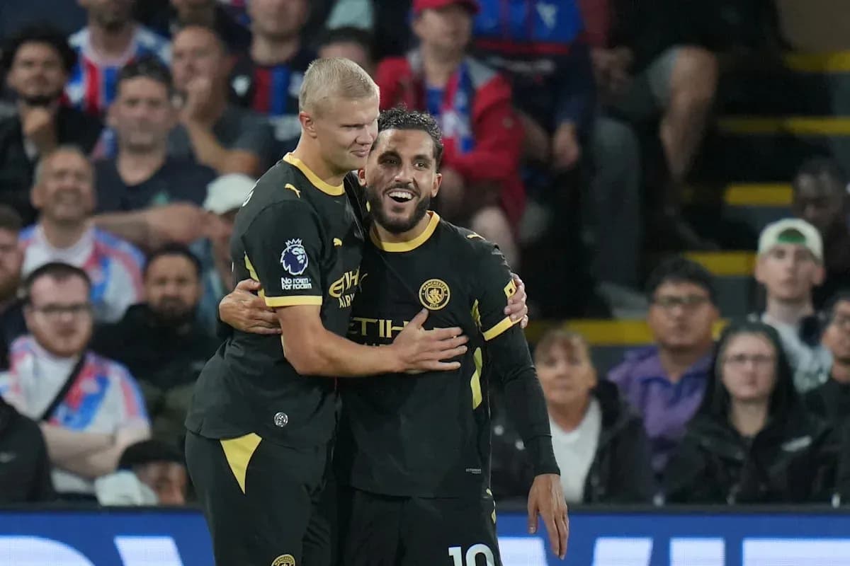 Two Manchester City players celebrating a goal Two Manchester City players celebrating a goal