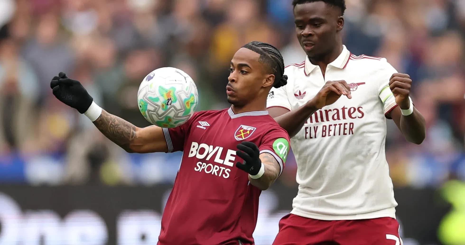 West Ham and Arsenal players battling for the ball West Ham and Arsenal players battling for the ball