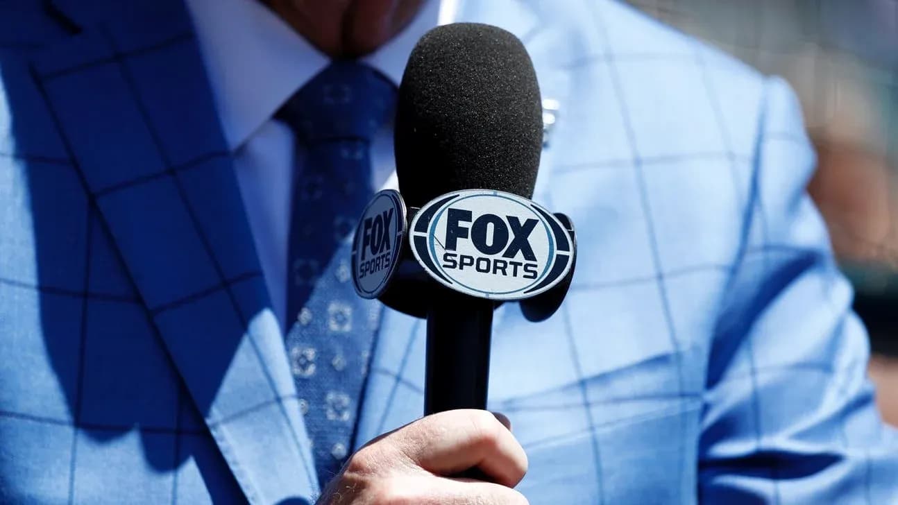 Microphone with FOX Sports logo held by announcer Microphone with FOX Sports logo held by announcer