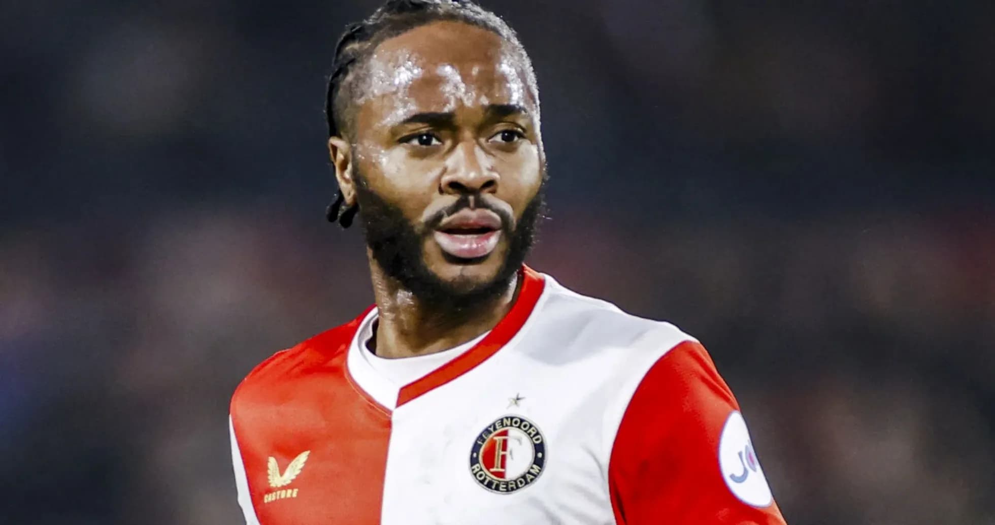 Feyenoord player in red and white kit on field Feyenoord player in red and white kit on field