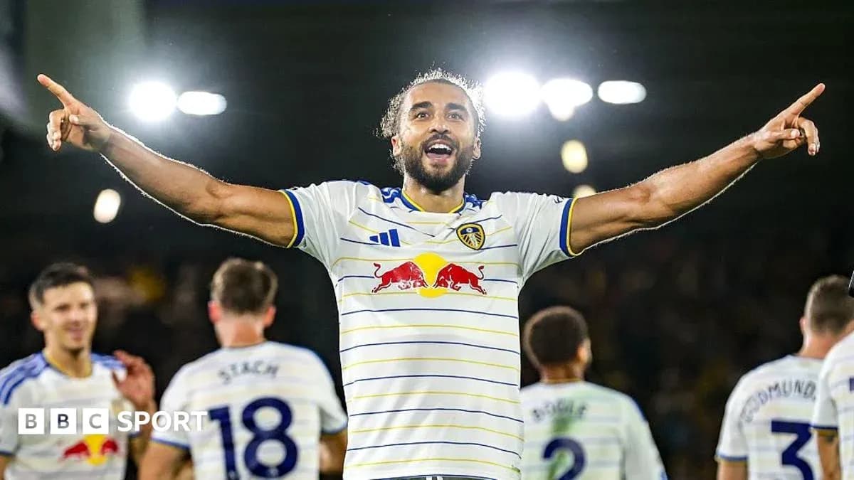 Player celebrating goal with teammates in background Player celebrating goal with teammates in background