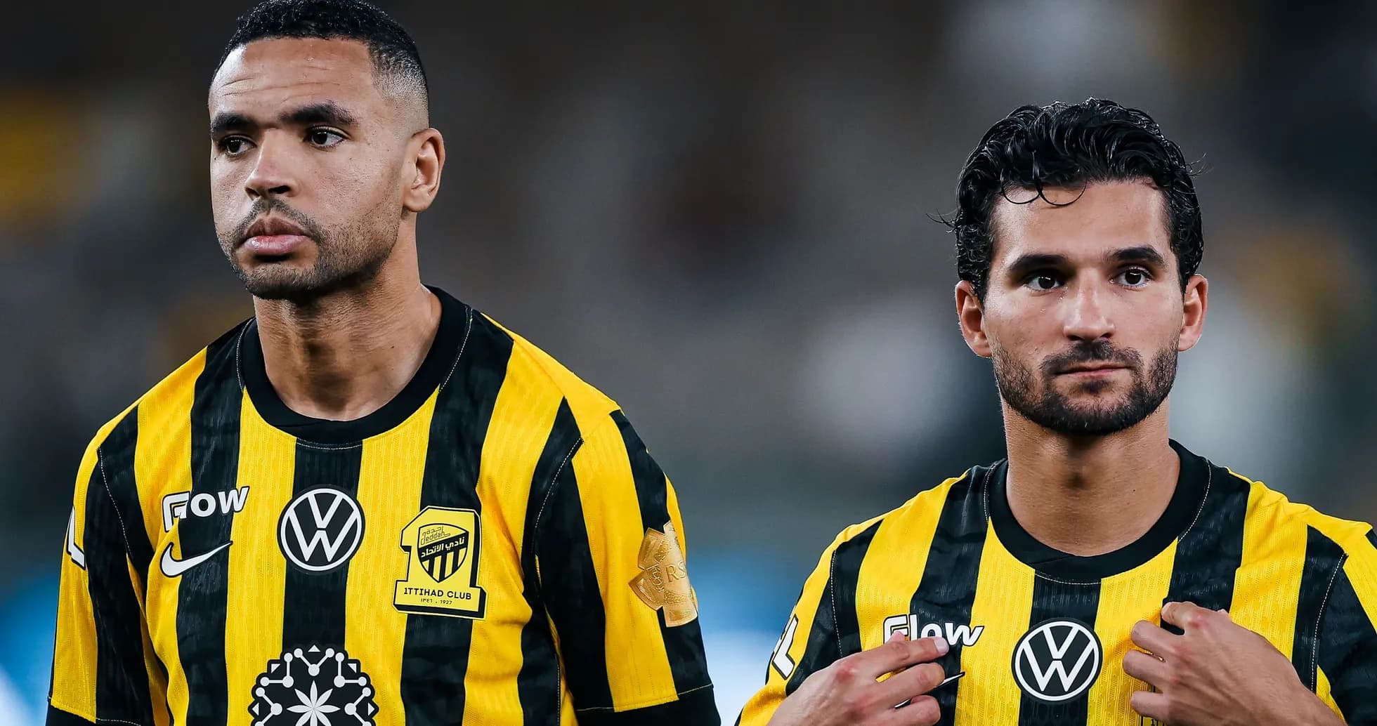 Two players in yellow and black jerseys during match Two players in yellow and black jerseys during match