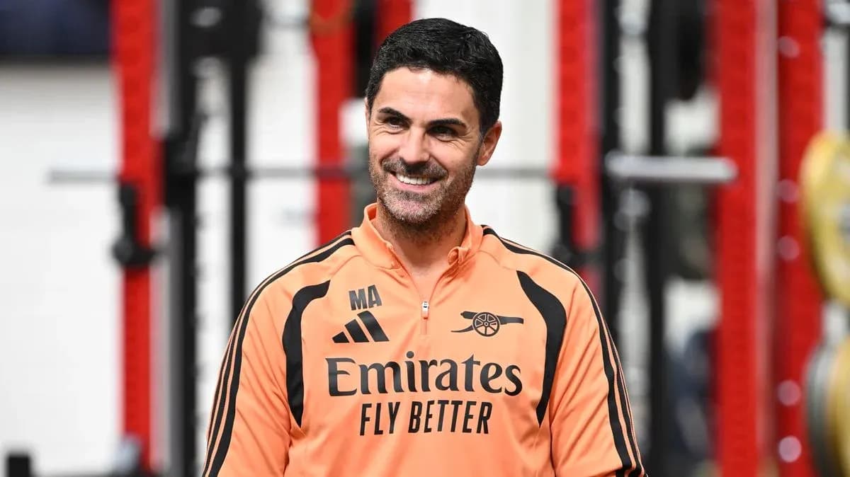 Coach in training gear smiling in gym setting Coach in training gear smiling in gym setting