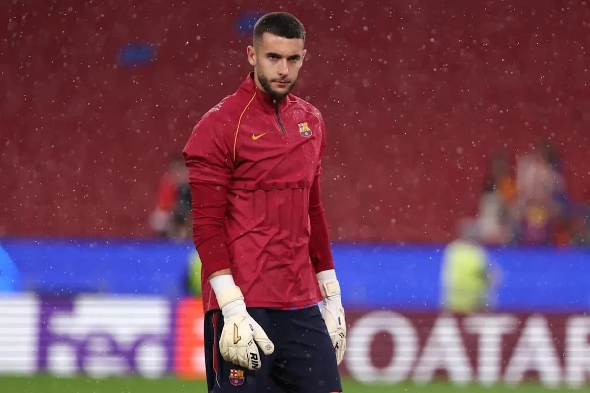 Goalkeeper warming up during rainy match conditions Goalkeeper warming up during rainy match conditions