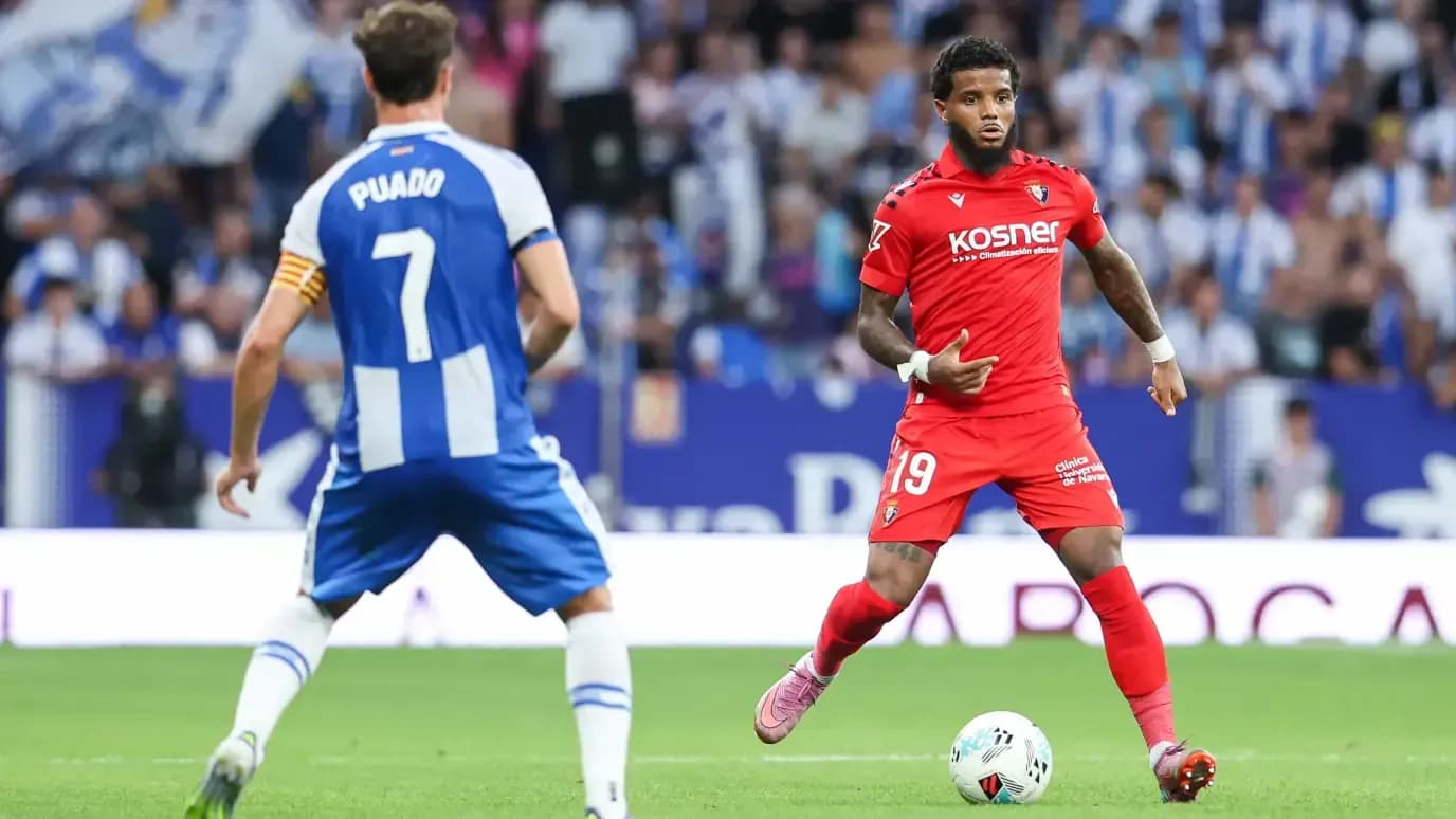 Player in red jersey dribbling against Espanyol Player in red jersey dribbling against Espanyol