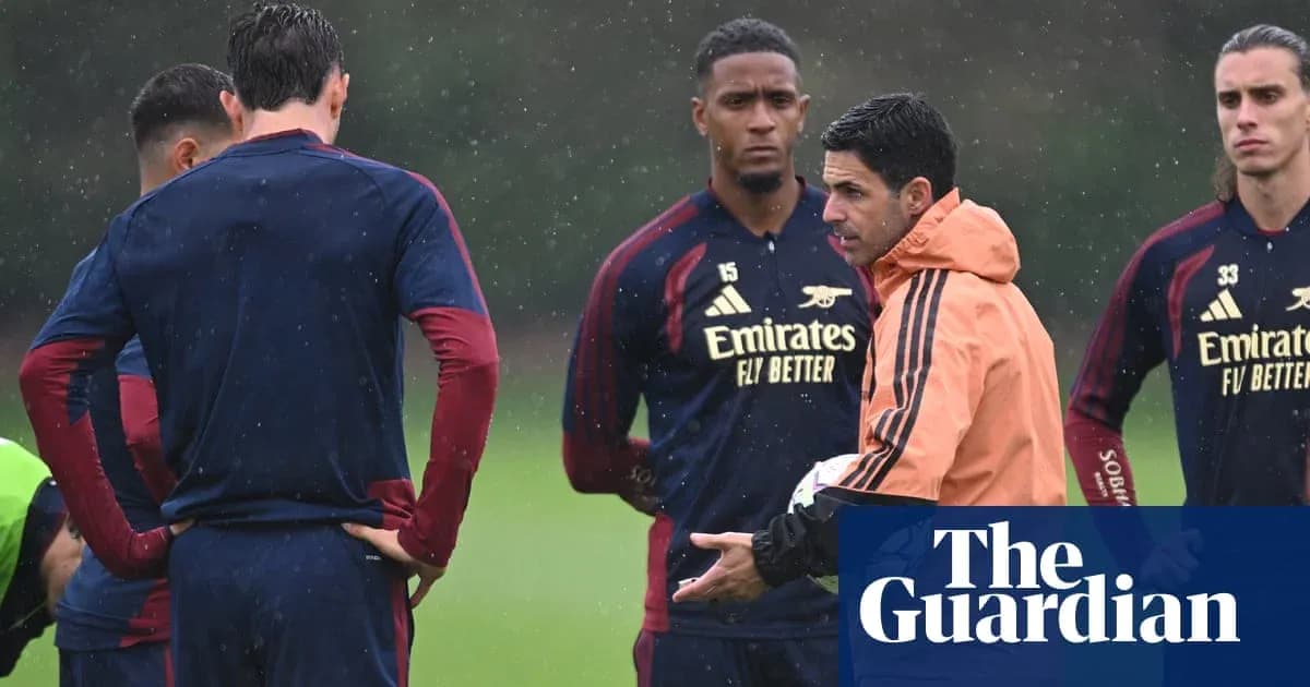 Manager instructing players during rainy training session Manager instructing players during rainy training session