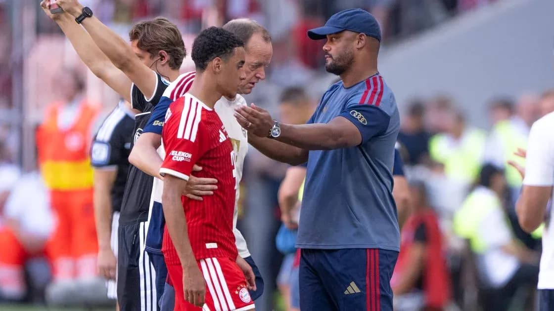 Player receiving guidance from coach during substitution Player receiving guidance from coach during substitution