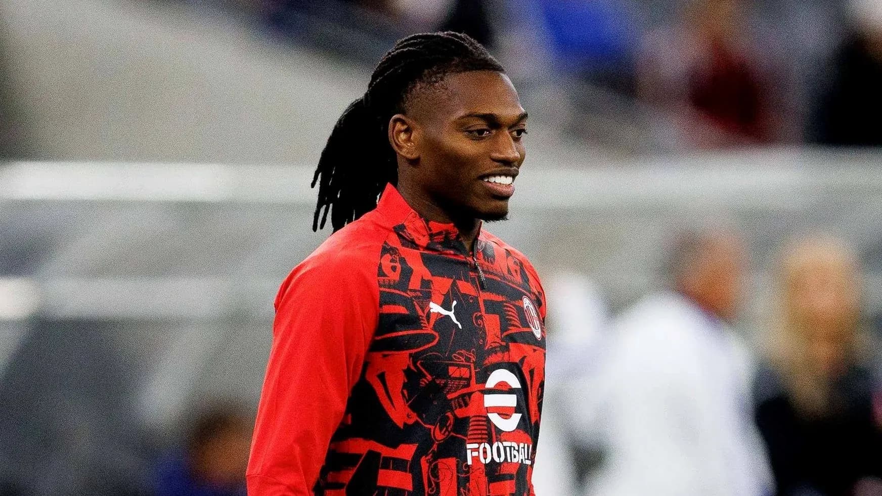 Player smiling while wearing red training jacket Player smiling while wearing red training jacket
