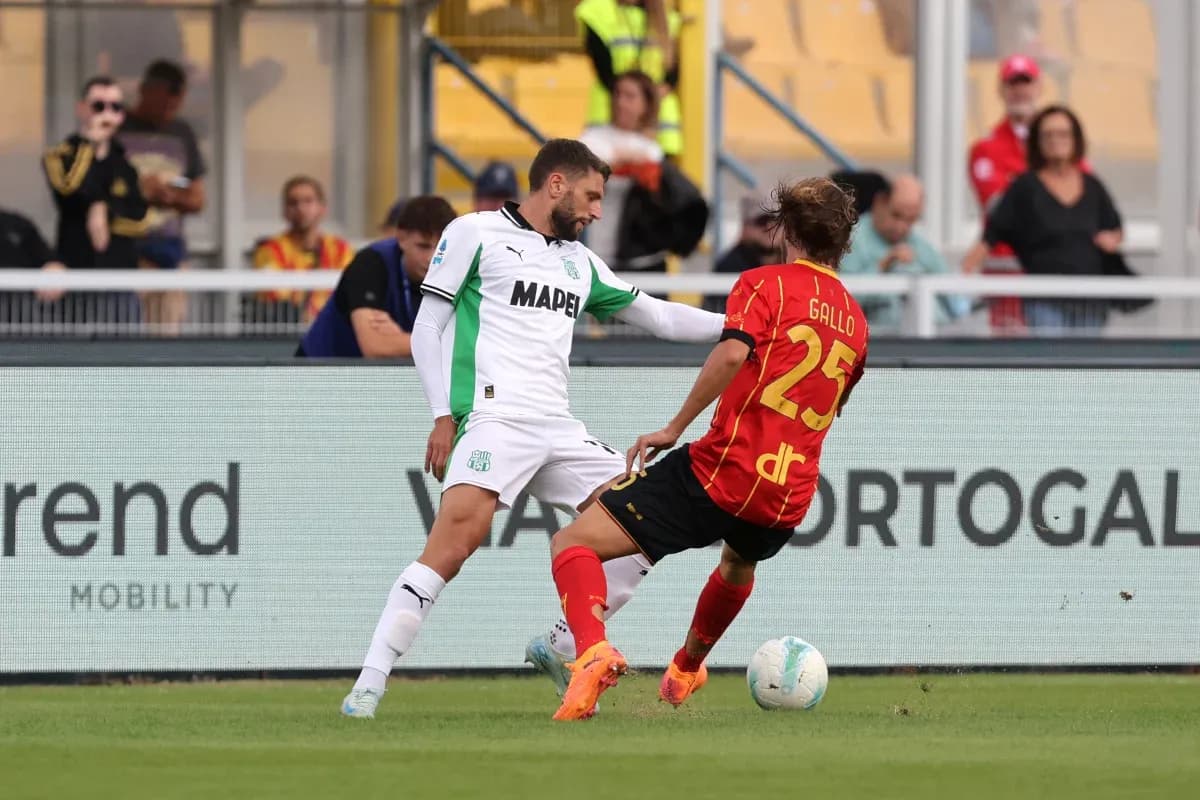 Sassuolo player tackling Lecce player during match Sassuolo player tackling Lecce player during match