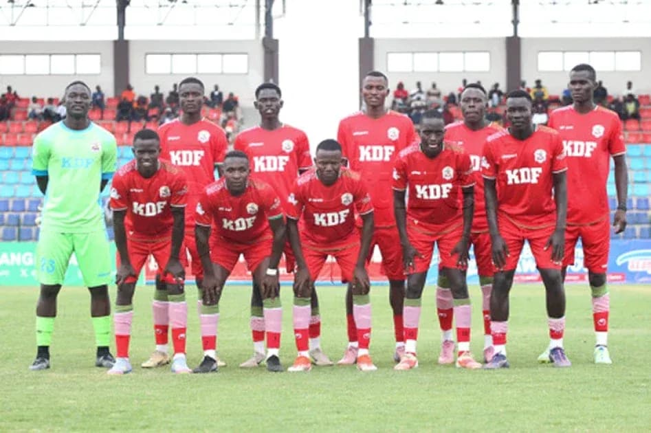 KDF football team posing for group photo on field KDF football team posing for group photo on field