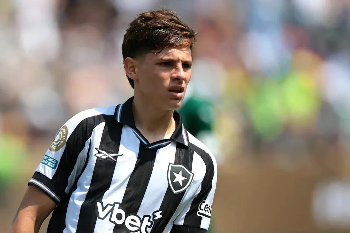 Player in black and white striped jersey on field Player in black and white striped jersey on field