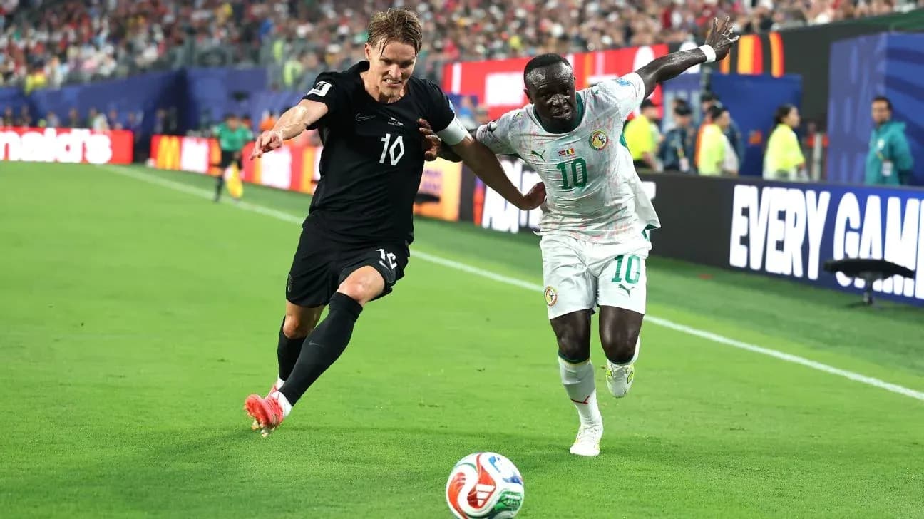 Two players competing for the ball on the field Two players competing for the ball on the field