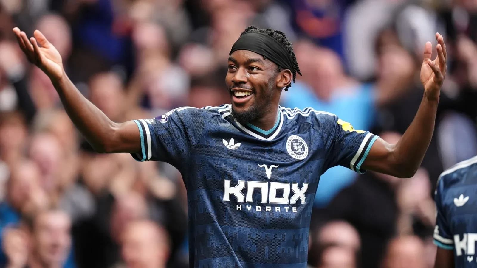 Player celebrating a goal with outstretched arms Player celebrating a goal with outstretched arms