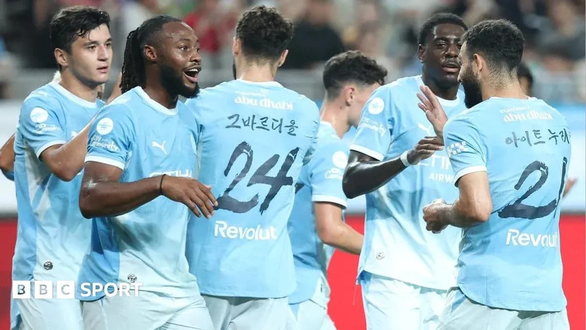 Players celebrating together in light blue jerseys Players celebrating together in light blue jerseys