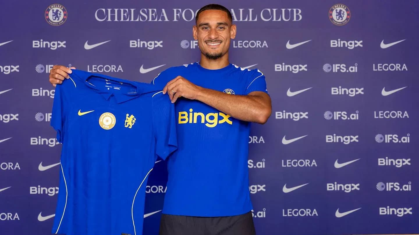 Player holding Chelsea jersey at press conference Player holding Chelsea jersey at press conference