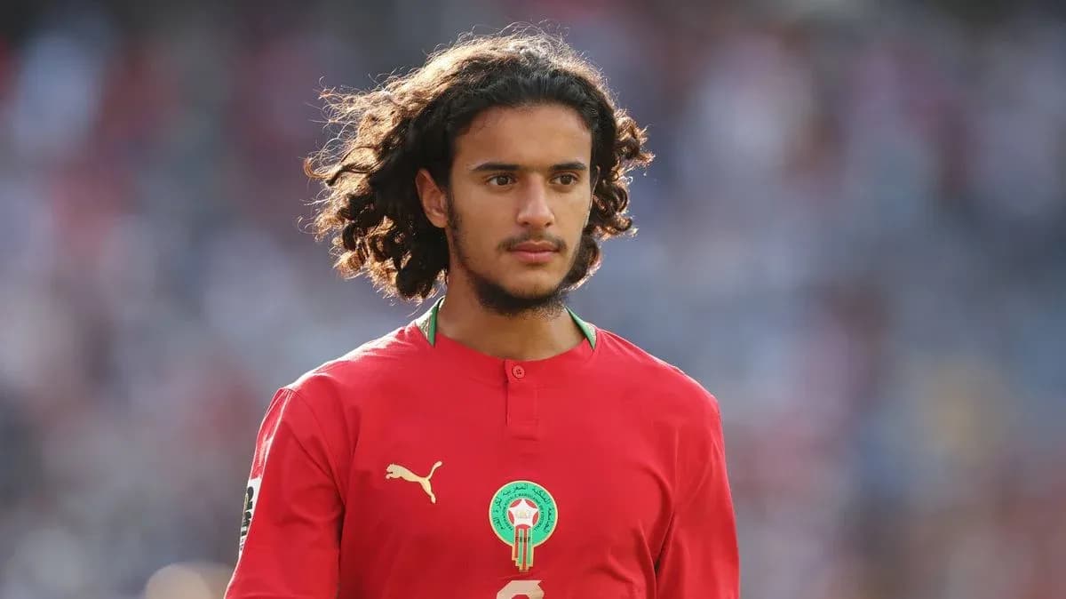Player wearing red Morocco jersey on field Player wearing red Morocco jersey on field
