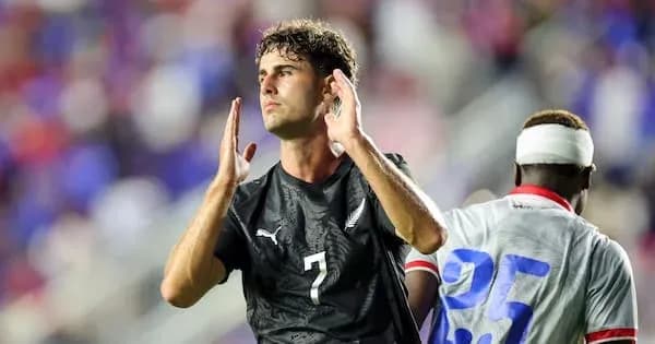 Player gesturing during soccer match with teammate Player gesturing during soccer match with teammate