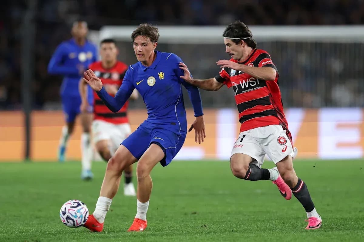Player in blue dribbling past opponent in red Player in blue dribbling past opponent in red