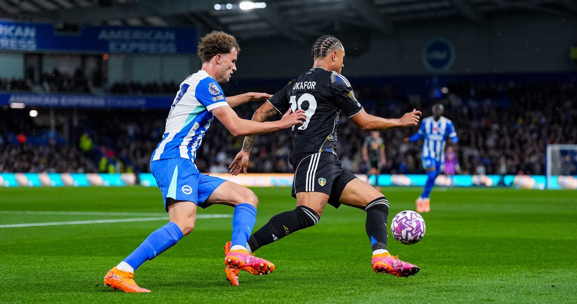 Player from Leeds attempting to evade Brighton tackle Player from Leeds attempting to evade Brighton tackle