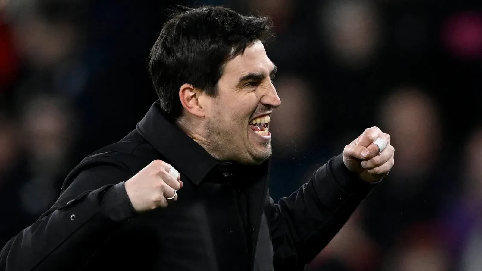 Coach celebrating a goal with clenched fists Coach celebrating a goal with clenched fists