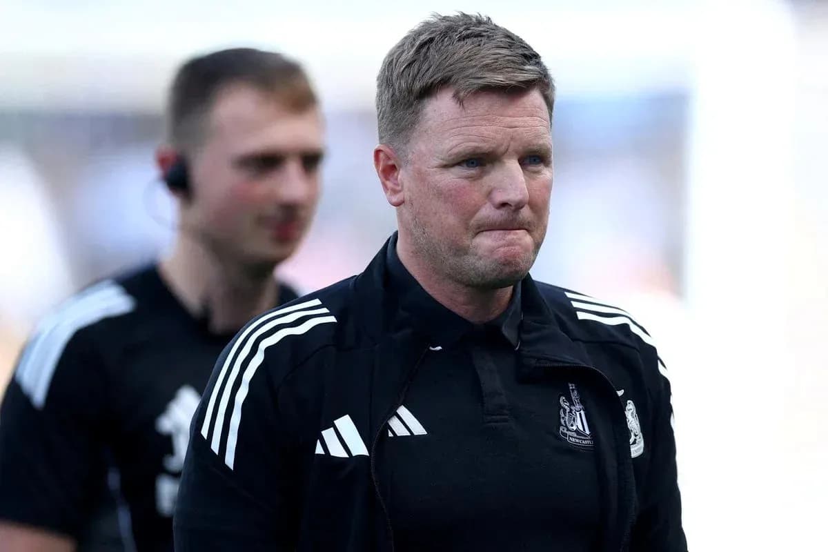 Manager walking on the pitch with assistant behind Manager walking on the pitch with assistant behind