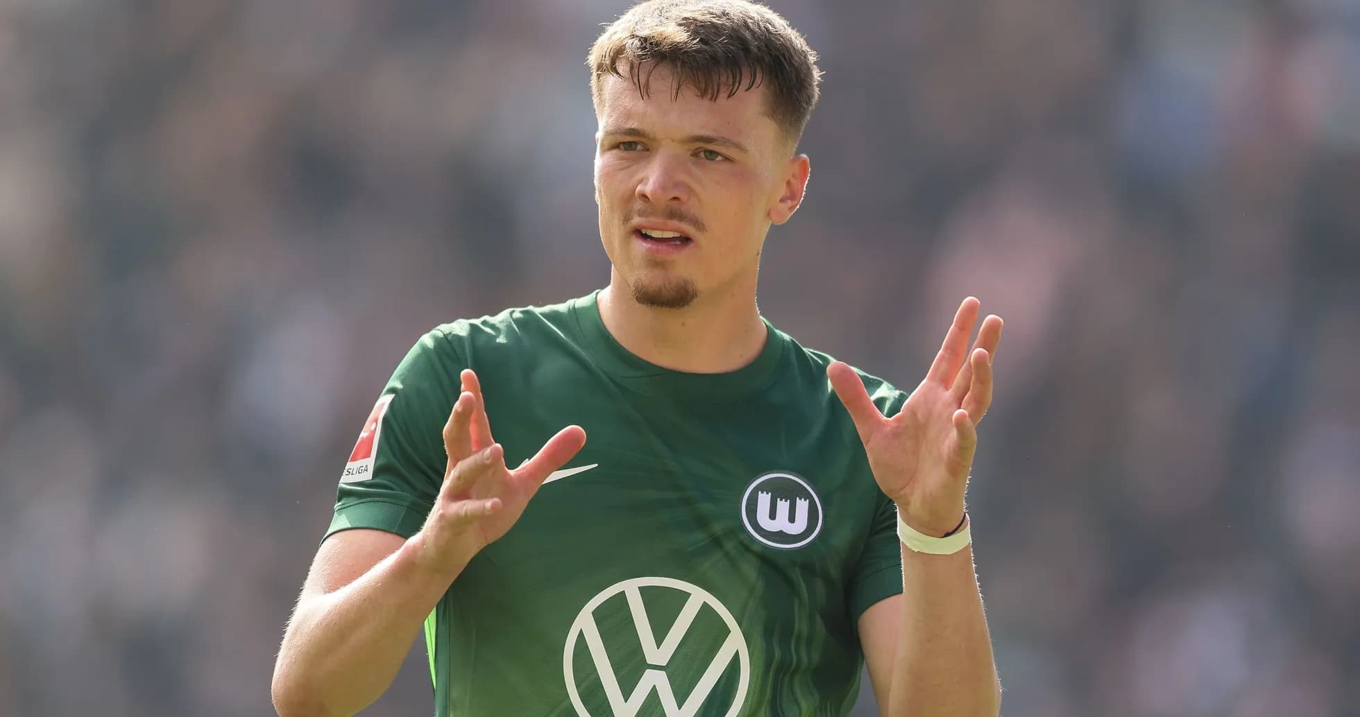 Player gesturing during a Bundesliga match Player gesturing during a Bundesliga match