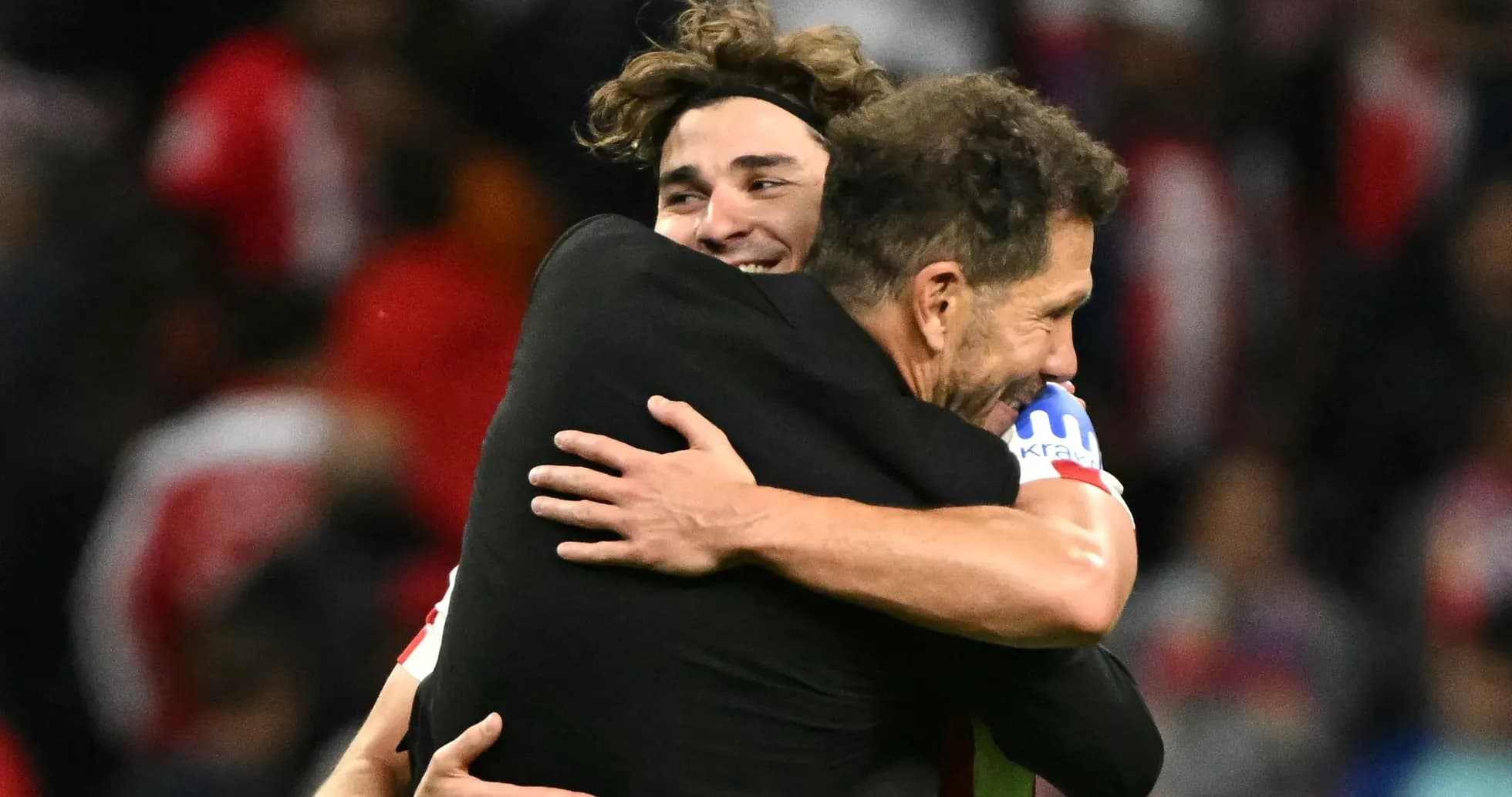 Player and coach embracing after match victory Player and coach embracing after match victory
