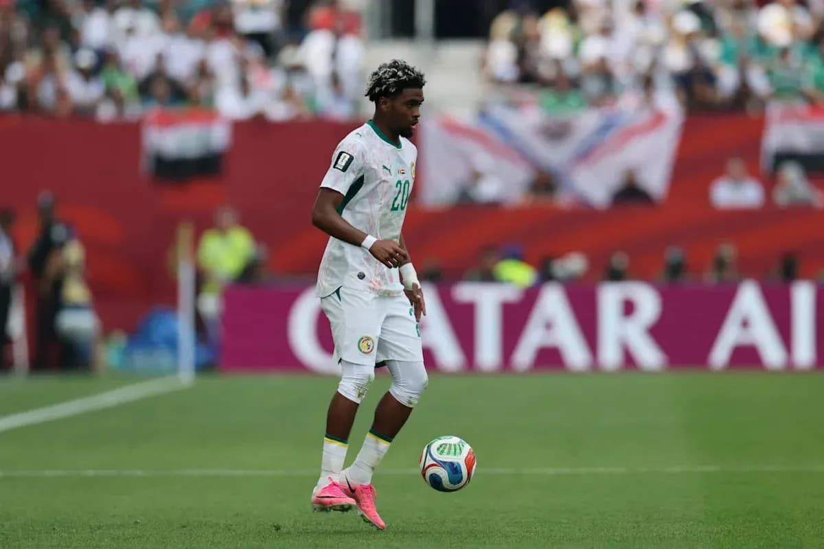 Player from Senegal controlling the ball on field Player from Senegal controlling the ball on field