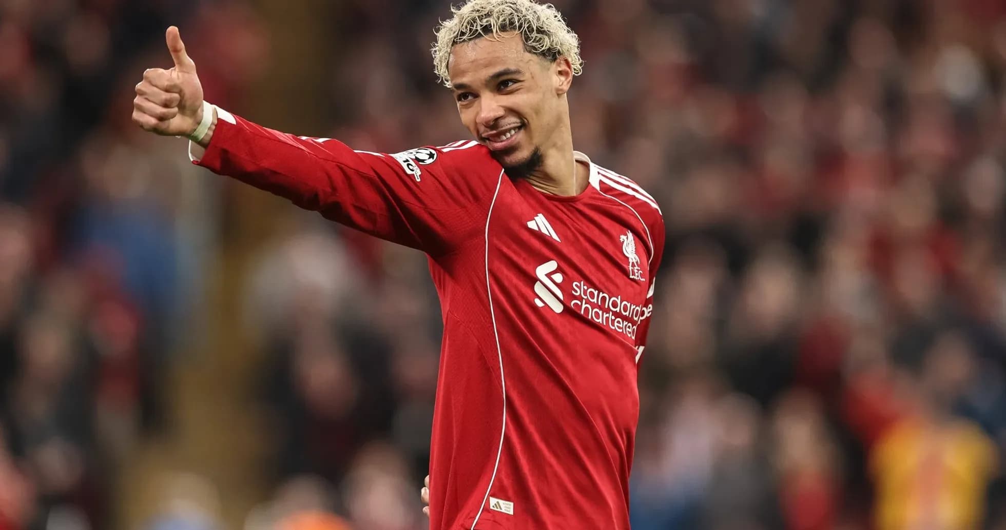 Player celebrating with thumbs up in Liverpool jersey Player celebrating with thumbs up in Liverpool jersey