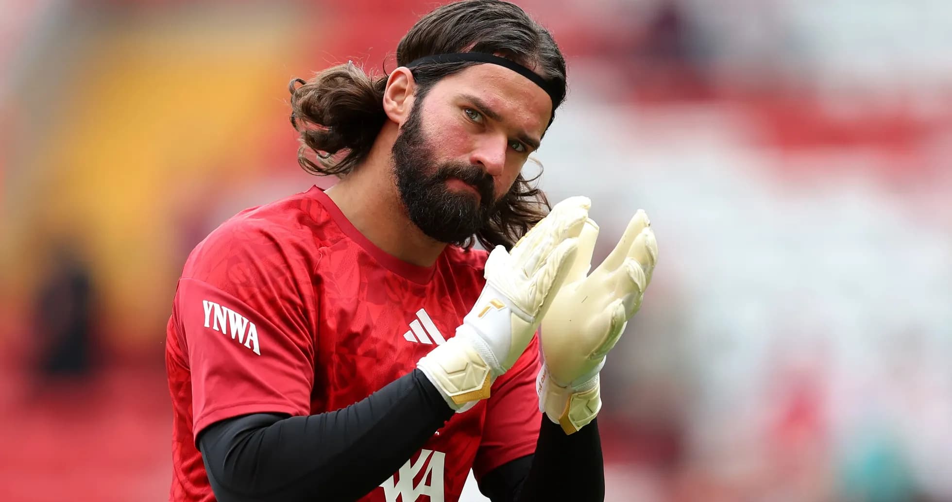 Goalkeeper clapping while wearing gloves and red jersey Goalkeeper clapping while wearing gloves and red jersey