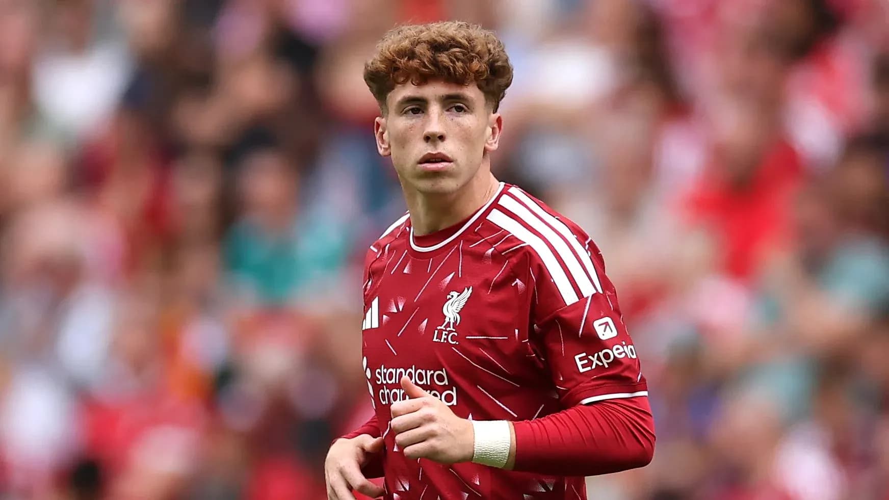 Liverpool player in red kit on the field Liverpool player in red kit on the field