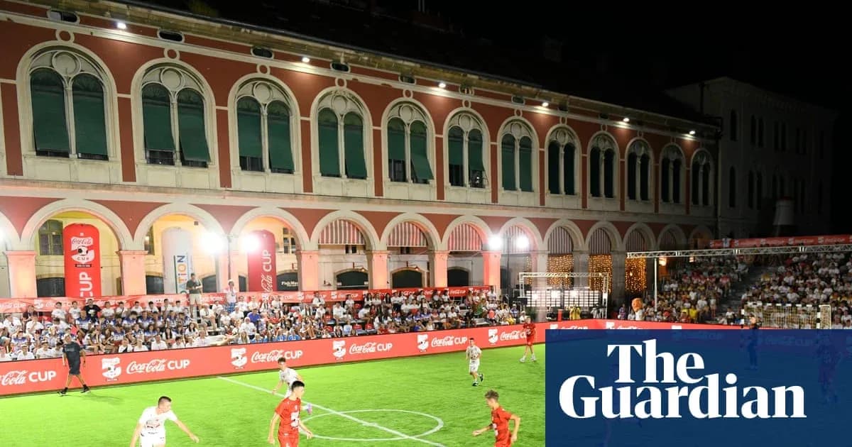 Players competing on a small football pitch at night Players competing on a small football pitch at night