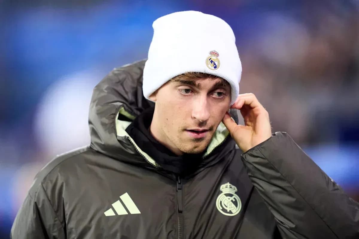 Player wearing Real Madrid jacket and beanie Player wearing Real Madrid jacket and beanie
