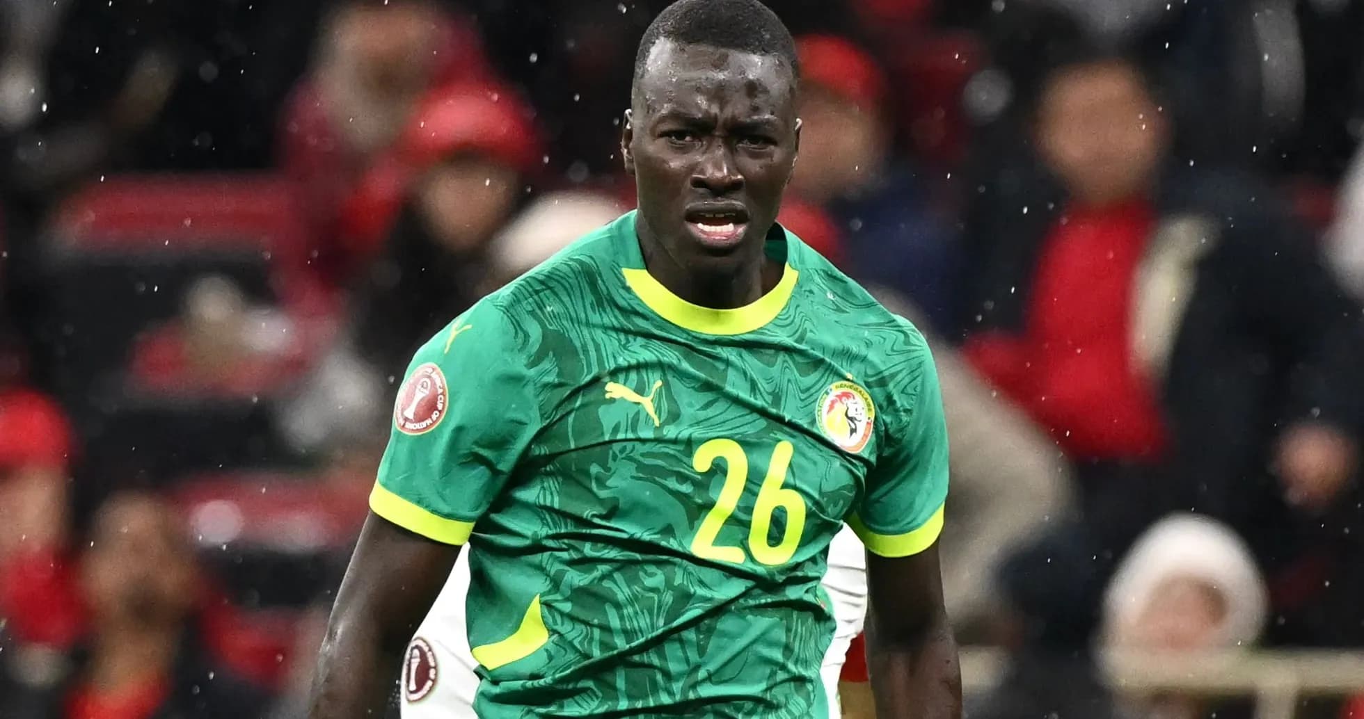 Player in green jersey during a football match Player in green jersey during a football match