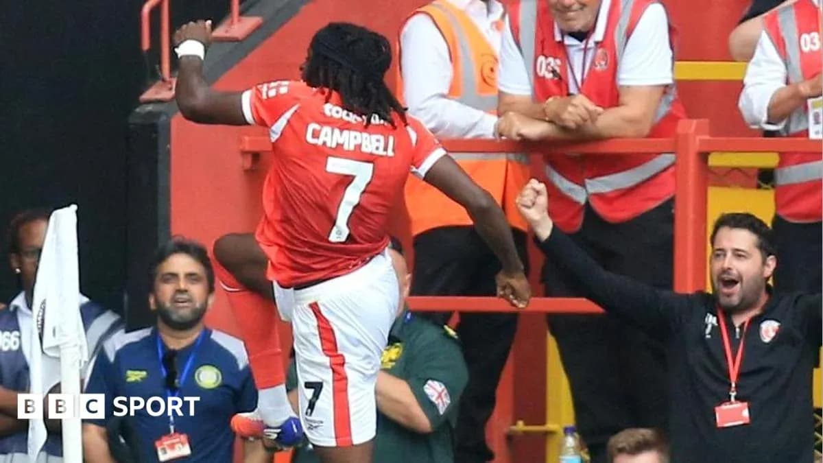 Player celebrating a goal in front of fans Player celebrating a goal in front of fans