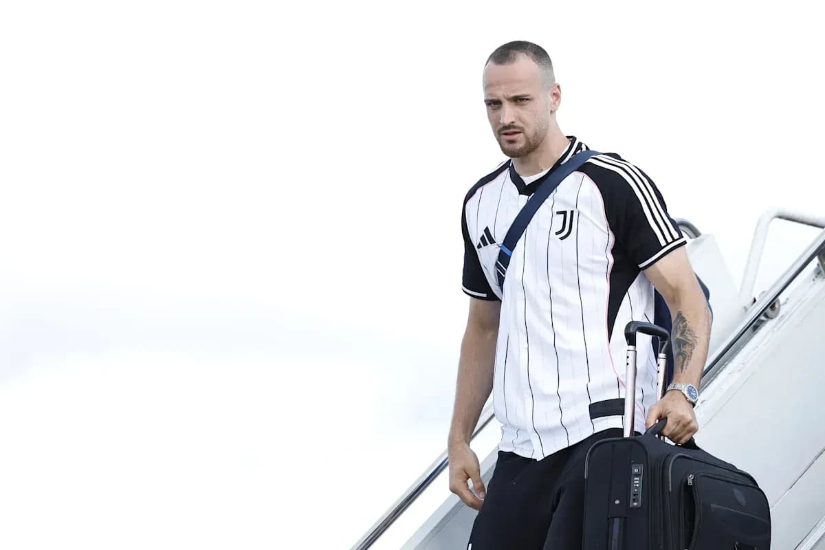 Player arriving with suitcase after disembarking plane Player arriving with suitcase after disembarking plane