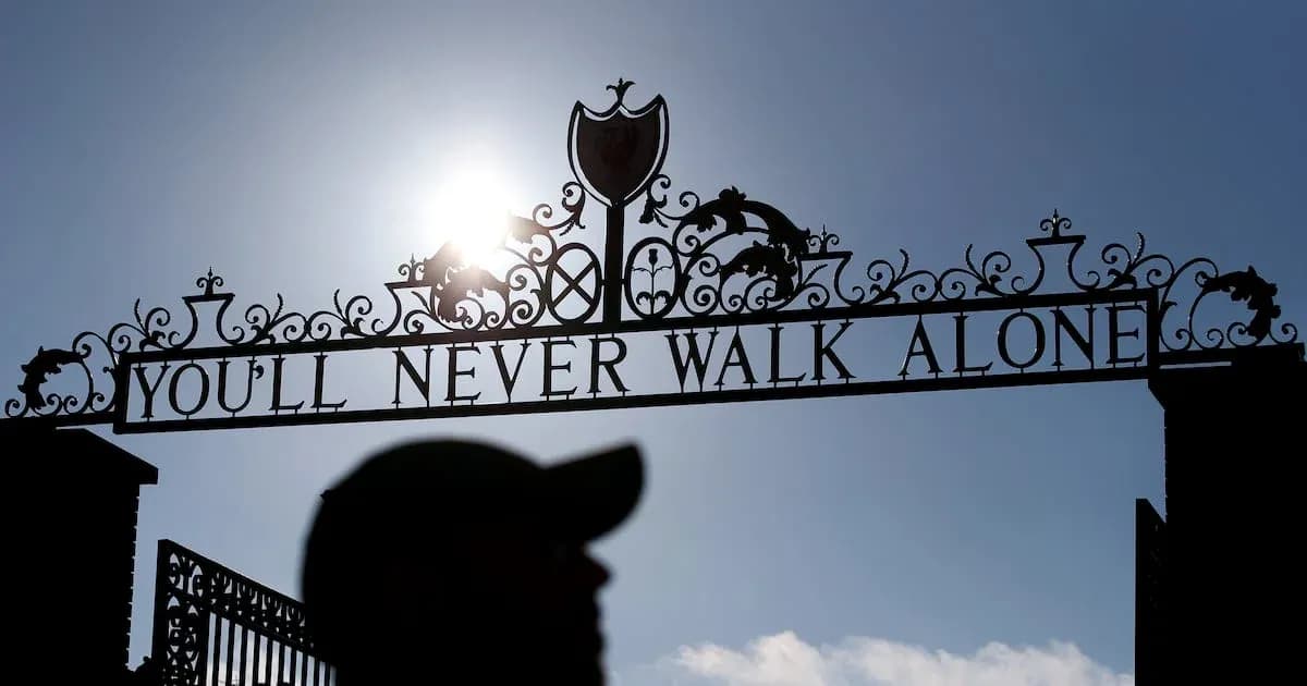 Sign reading 'YOU'LL NEVER WALK ALONE' at stadium entrance Sign reading 'YOU'LL NEVER WALK ALONE' at stadium entrance