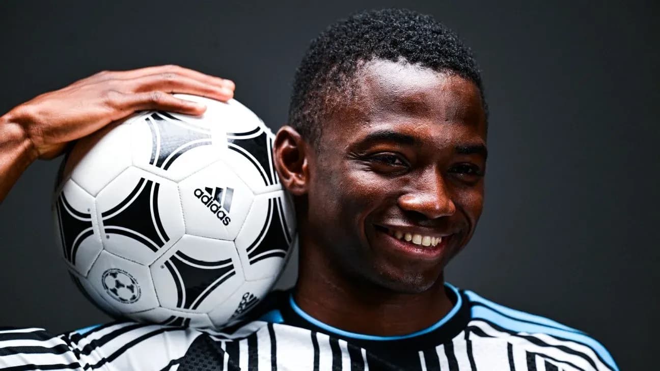 Player holding a soccer ball on shoulder Player holding a soccer ball on shoulder