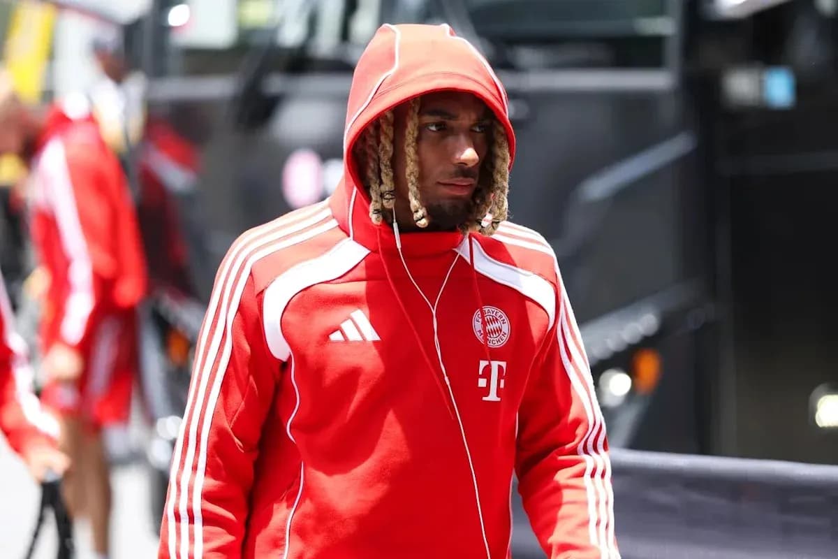 Player arriving at stadium in red team tracksuit Player arriving at stadium in red team tracksuit